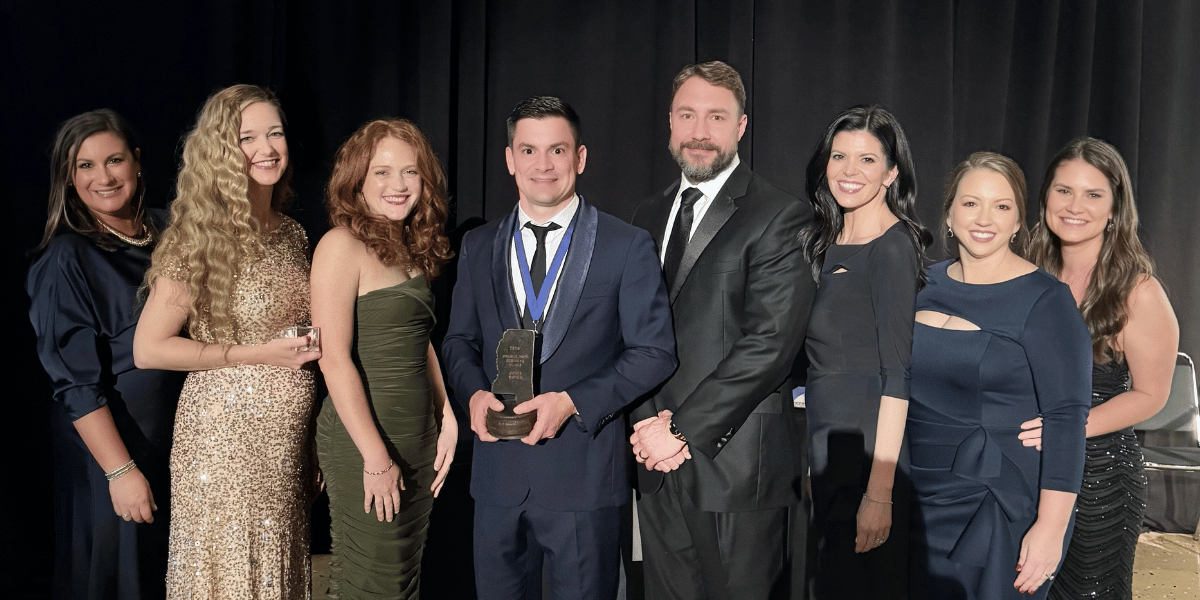 Jones Capital Representatives posing together for a photo after receiving the Charlie Holt Business Award. 